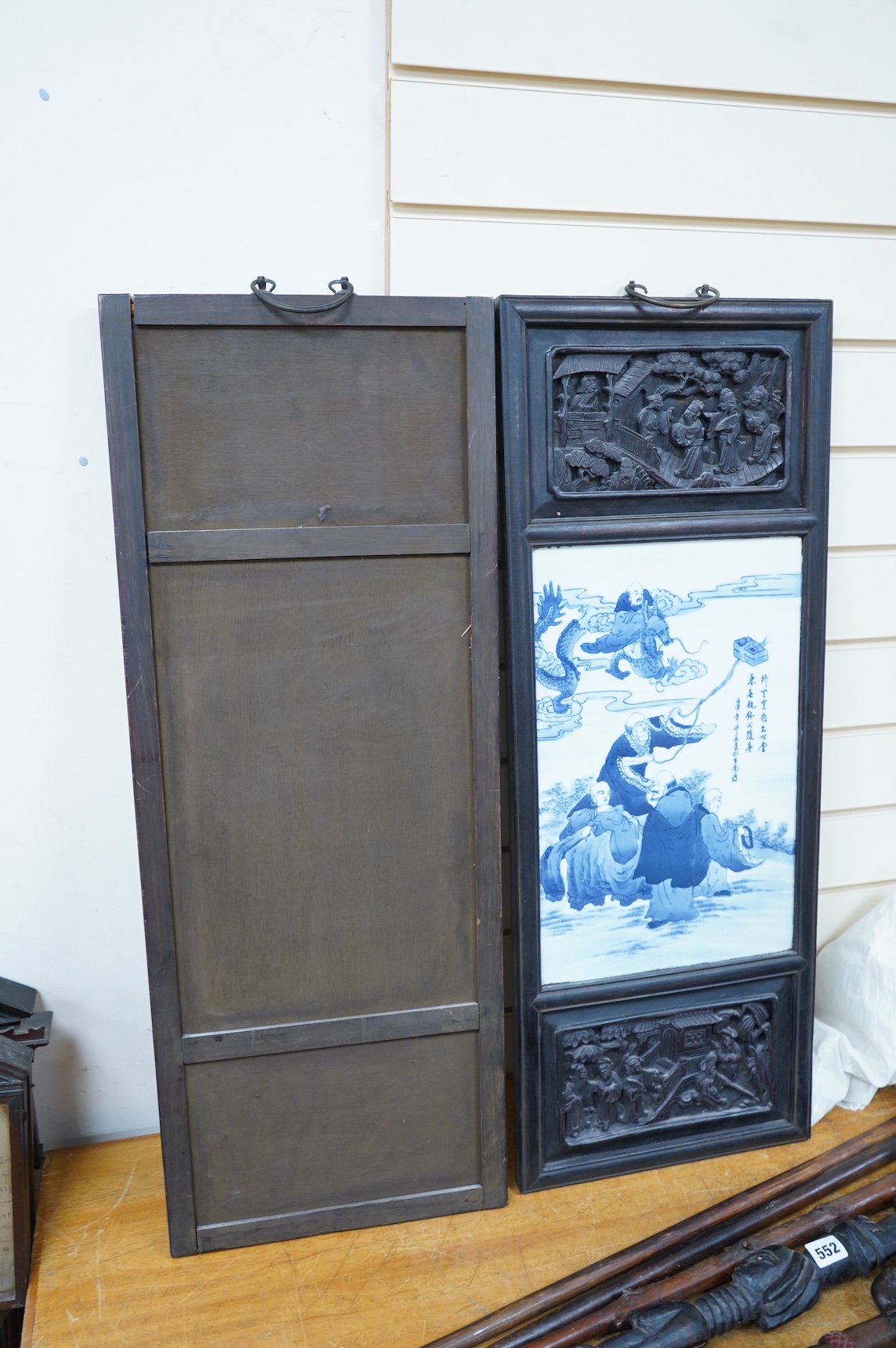 A pair of Chinese blue and white porcelain plaques, inset carved wood frames, 84cm x 32cm
